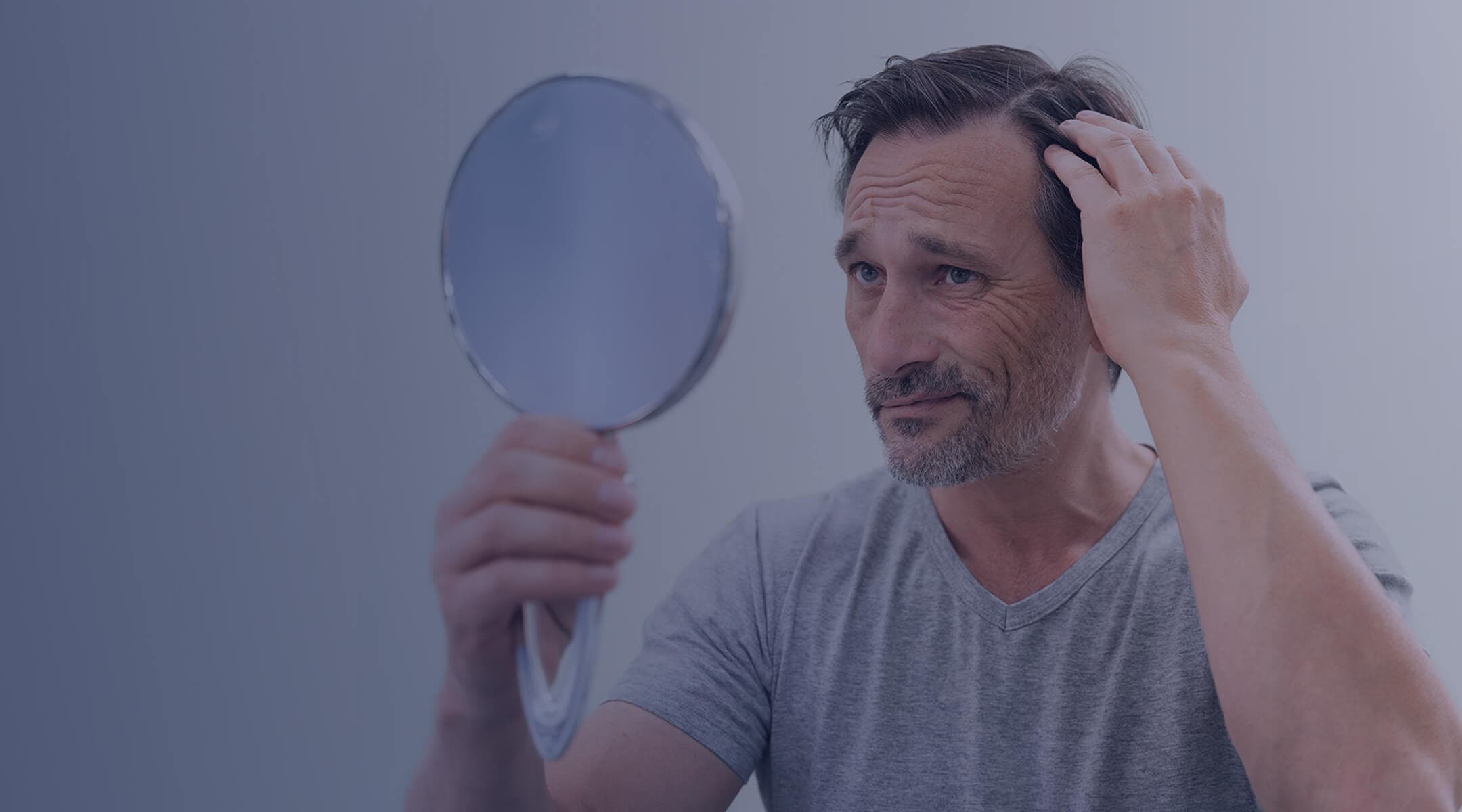 A confident man with a full, healthy head of hair