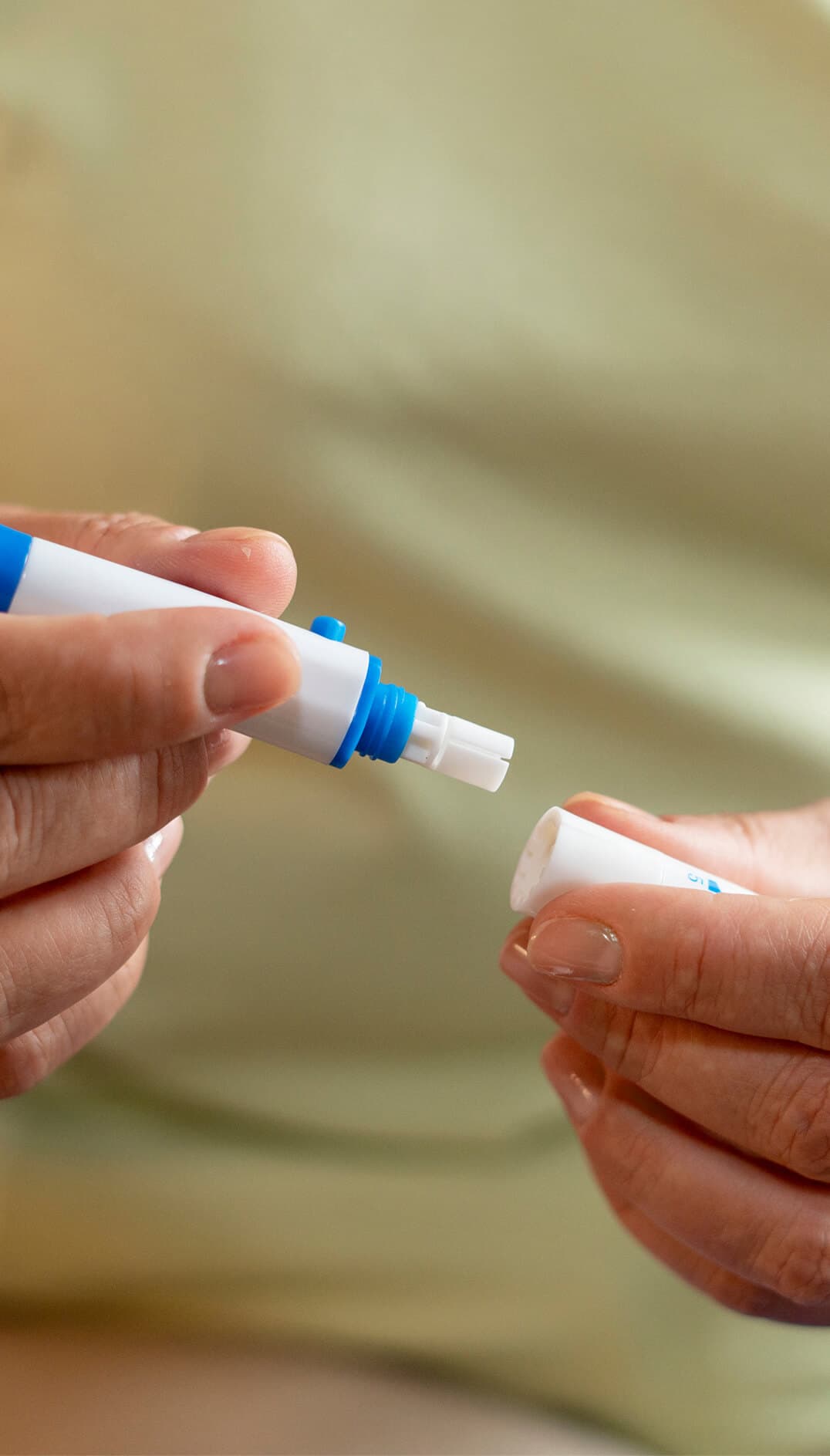 Hands preparing a precision peptide injection pen