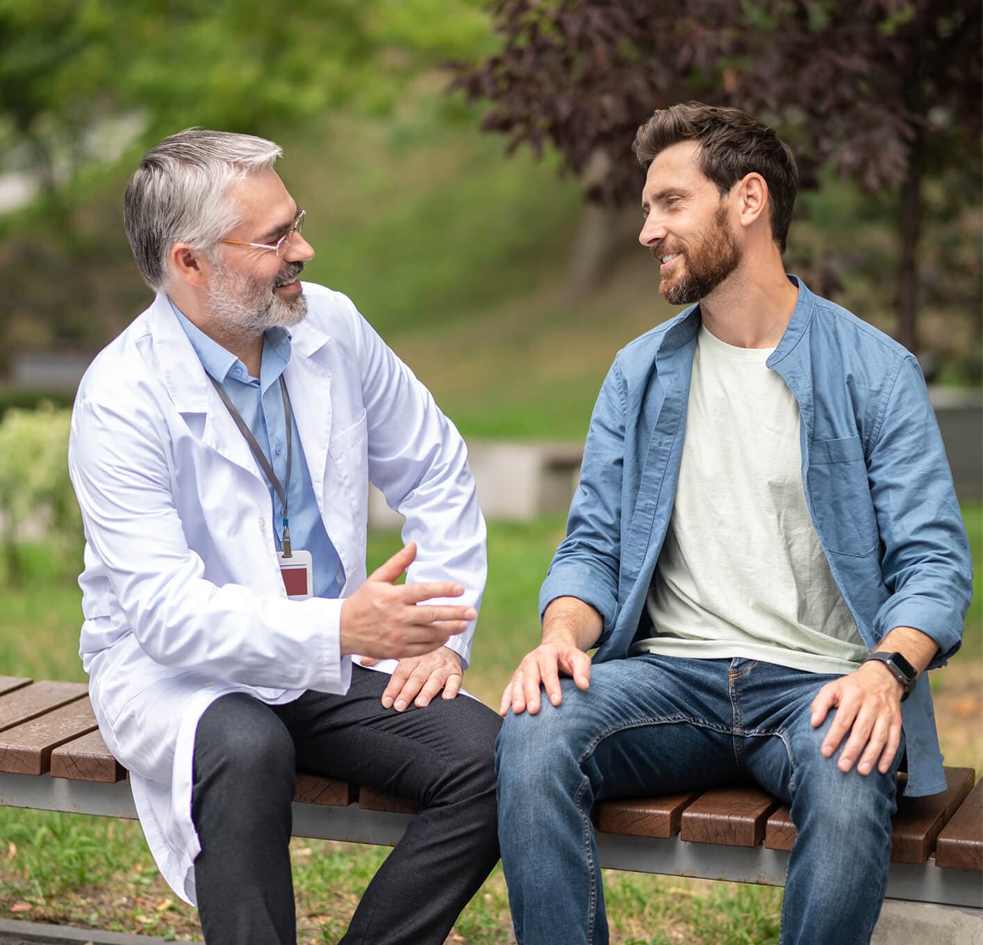 A man smiling during a consultation walk outdoors